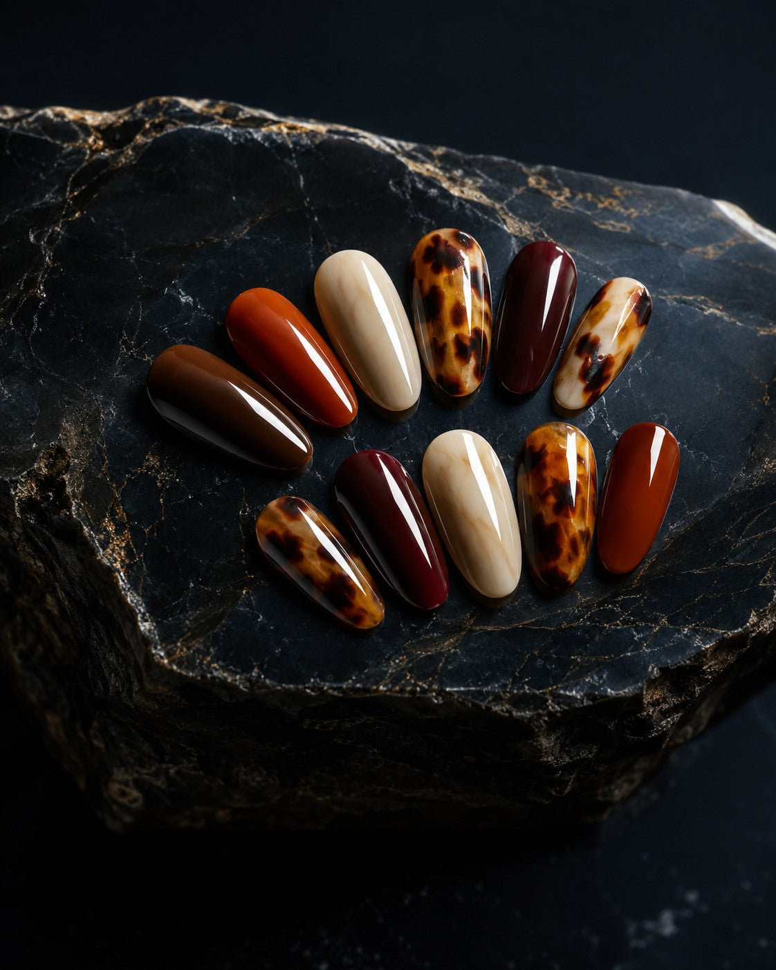 Autumn press-on nails in rust, chocolate, burgundy and cream with a tortoiseshell accent