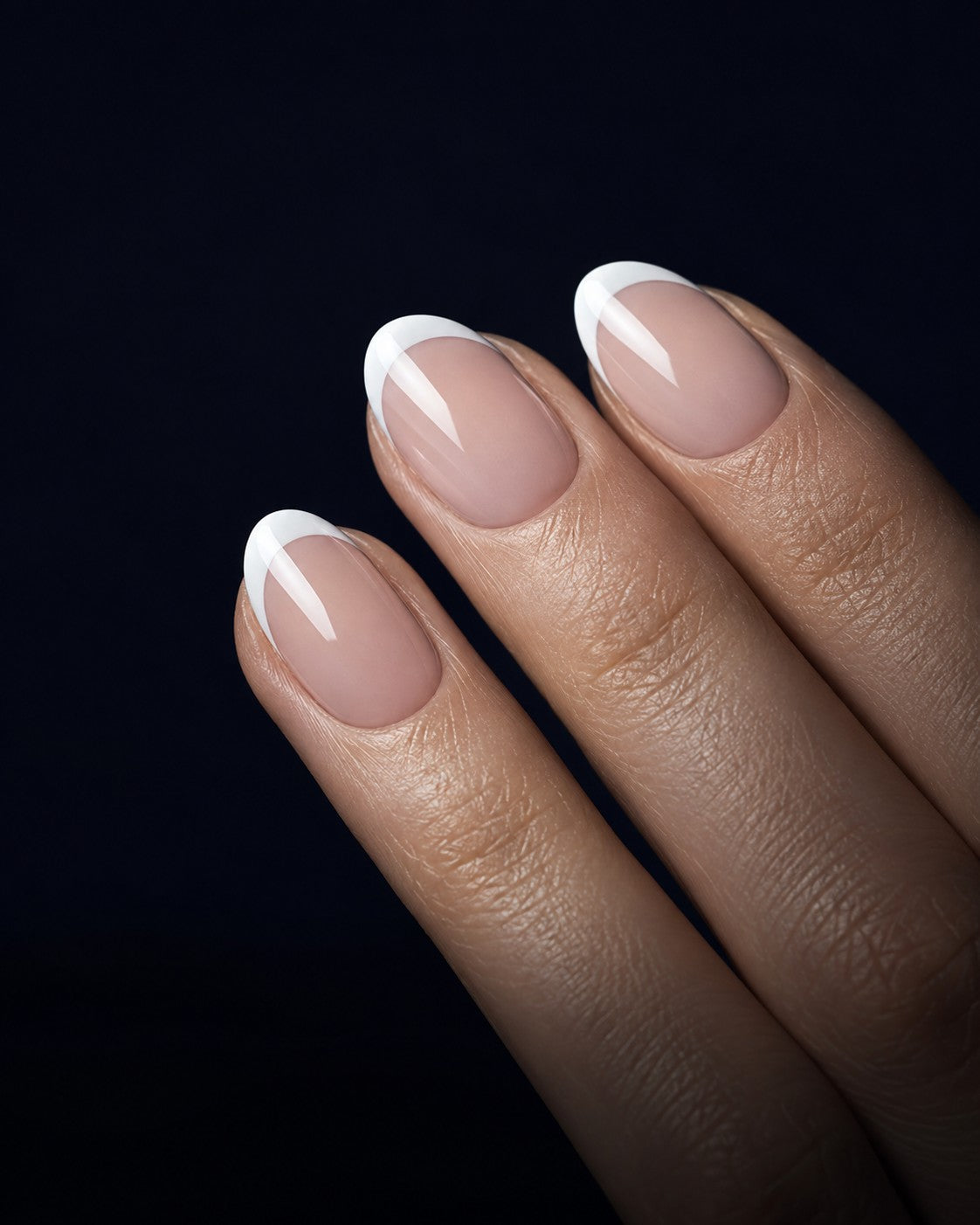 Short almond press-on nails with a crisp white French tip over a sheer pink base