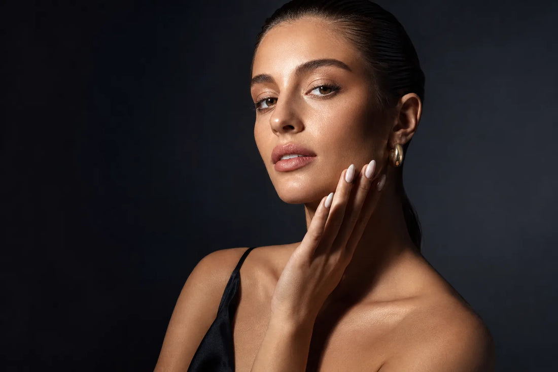 Editorial portrait, milky nude almond press-on nails, gaze to camera, midnight ground