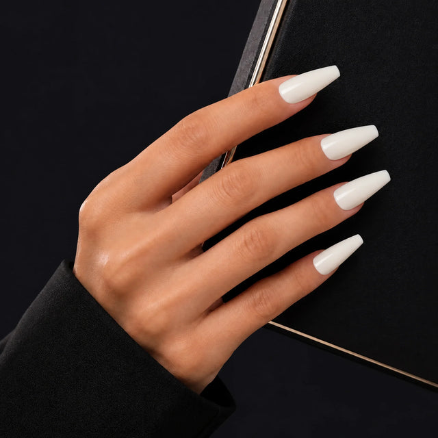 Milk Glaze Press-On Nails, Long Coffin — Main sur pochette noire (liseré doré)